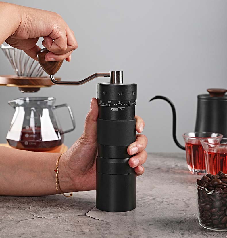 Manual coffee grinder creating perfect espresso crema foam.