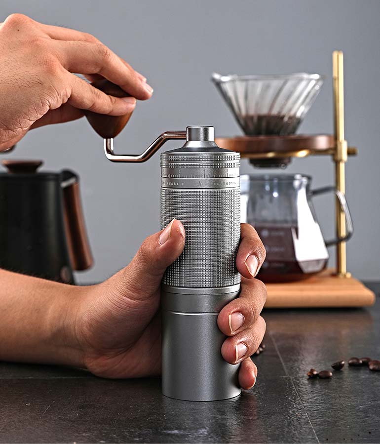 Close-up on hand grinding coffee