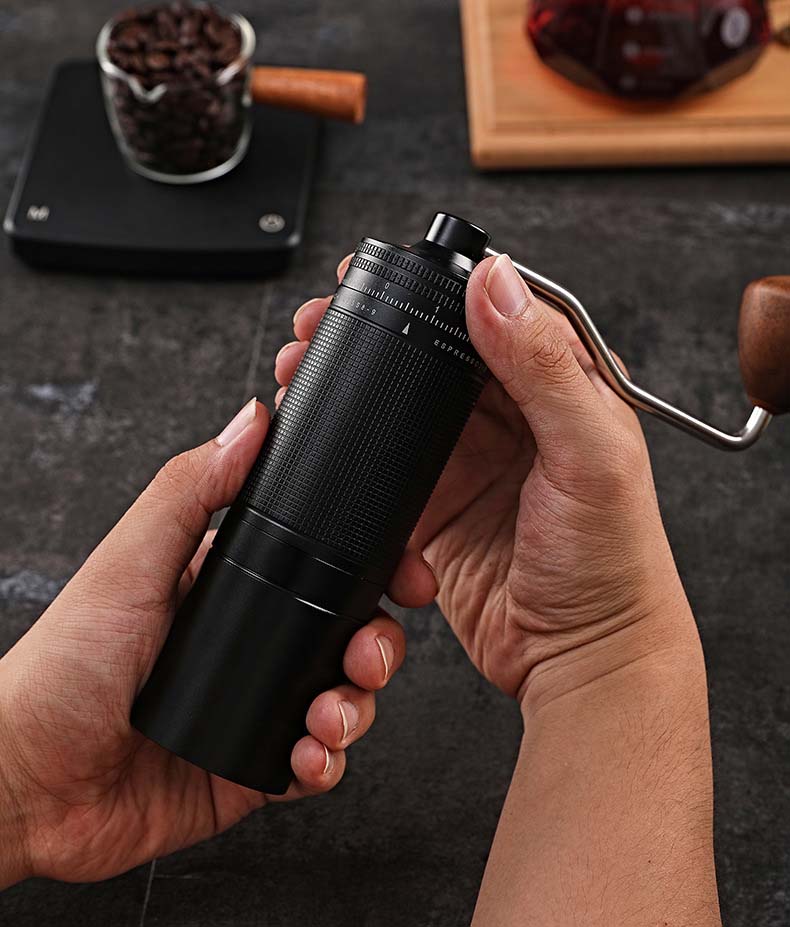 Close-up on hand grinding coffee