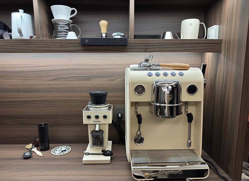 A compact small coffee grinder sitting neatly on a small kitchen counter