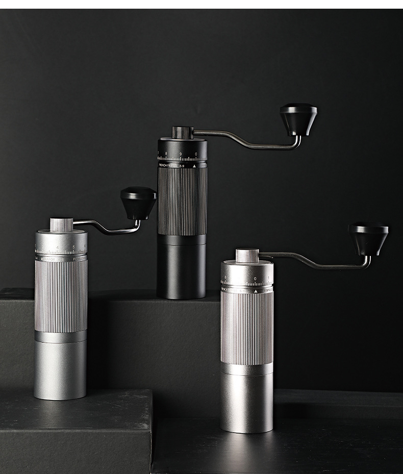 A collection of compact small coffee grinders in a cozy home kitchen setting